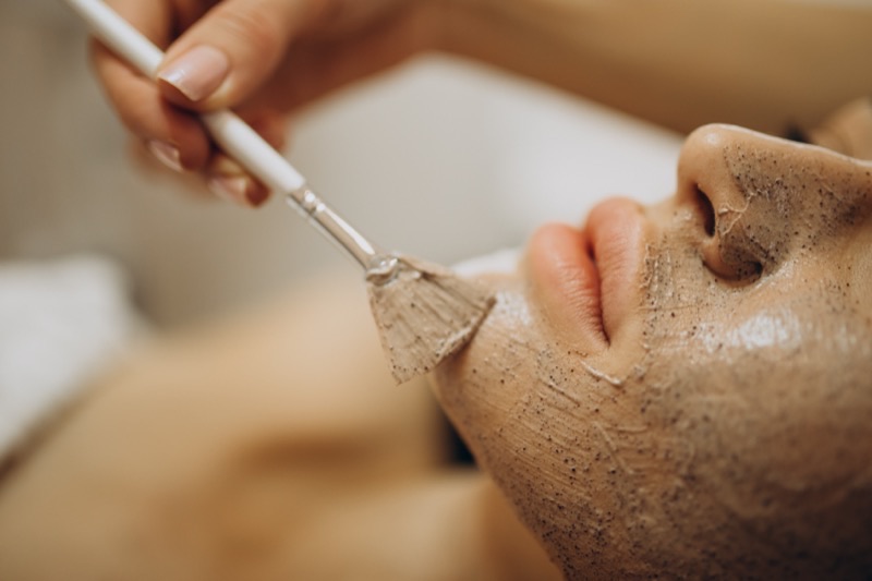 Esthetician student applying a facial treatment during skincare training